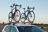 two bicycles mounted on roof of car