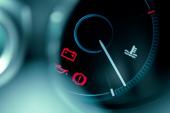 close-up on car dashboard and warning icon